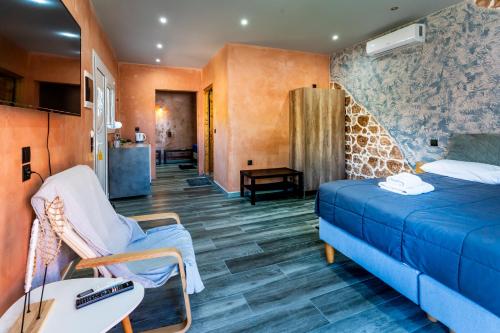 a room with a blue bed and a giraffe wall at Anna Studios in Marathias
