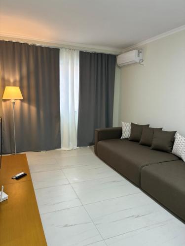 a living room with a couch and a table at Bejart Apartment 9 in Tirana