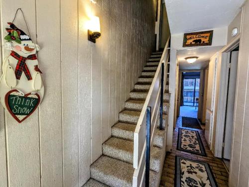 a staircase in a house with a christmas sign on the wall at Snow Summit Townhouse Unit 69 in Big Bear Lake