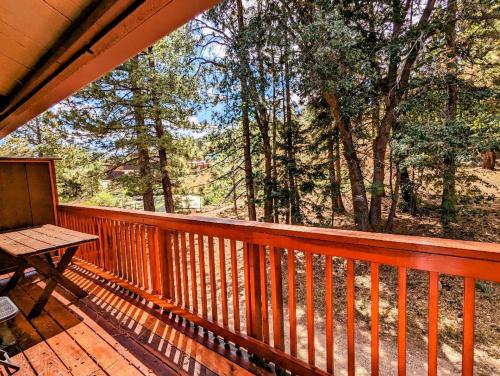 a porch with a table and a bench on a deck at Snow Summit Townhouse Unit 52 in Big Bear Lake