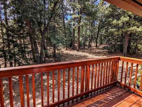 a wooden deck with a view of the woods at Snow Summit Townhouse Unit 52 in Big Bear Lake