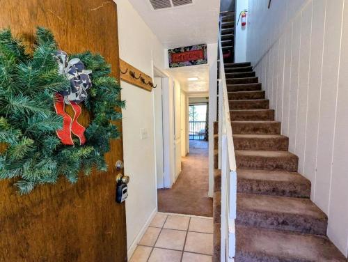 a hallway with a christmas wreath on the door at Snow Summit Townhouse Unit 09 in Big Bear Lake