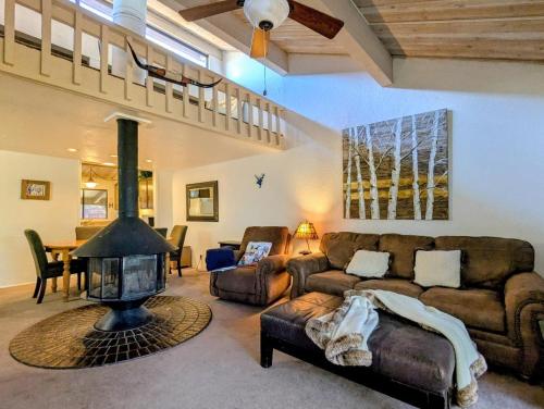 a living room with a couch and a fireplace at Snow Summit Townhouse Unit 09 in Big Bear Lake