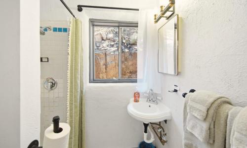 a bathroom with a sink and a window at Dam Site Lodging in Truth or Consequences