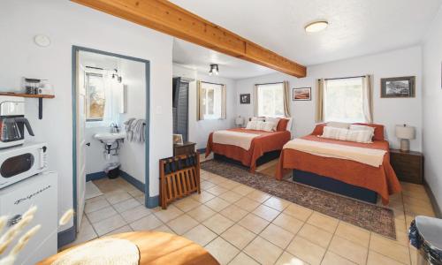 a room with two beds and a sink in it at Dam Site Lodging in Truth or Consequences