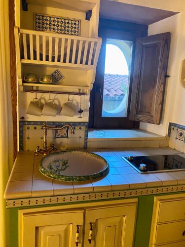 a kitchen with a sink and a counter top at Romeo e Giulietta Scilla in Scilla