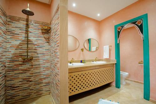 a bathroom with a sink and a shower at Riad Dar Mima Hnina - 2 Pools, Breakfast, 10' From Jamaa el-Fna, 10' From Airport in Marrakesh