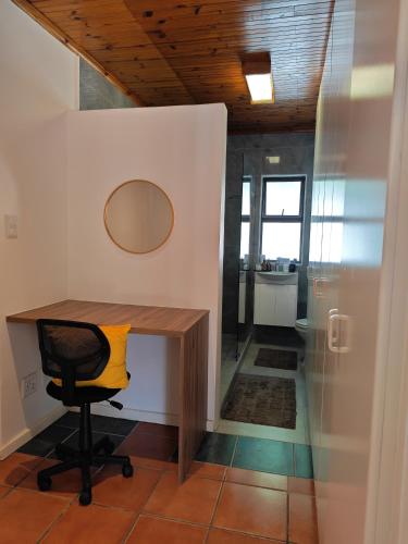 an office with a desk and a chair with a mirror at Kubata Diame B&B in Cape Town