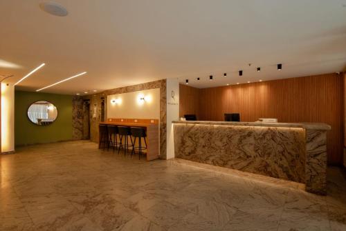 a lobby with a bar in the middle of a room at Regency Copacabana Hotel in Rio de Janeiro