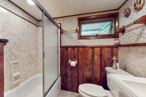 a bathroom with a toilet and a tub and a sink at Adirondacks in Style! Lake House w/ Deck, Fire Pit in Hadley