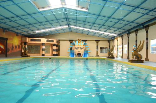 a large swimming pool with a lion head on the wall at Caverá Country Park in Araranguá