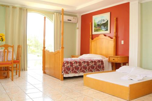 a hotel room with two beds and a window at Caverá Country Park in Araranguá
