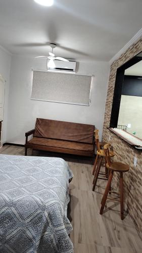 a bedroom with a bed and a mirror at Calmaria in Arraial do Cabo