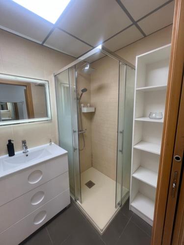 a bathroom with a shower and a sink at Coblanca 41-spectacular views-gym-heated pool-sauna-jacuzzi-wifi-3 minutes walk from the sear in Benidorm
