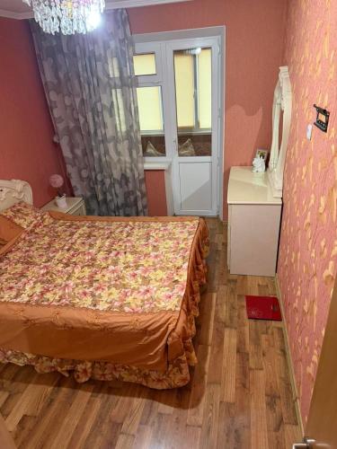 a bedroom with a bed and a dresser and a window at City Relax in Bălţi
