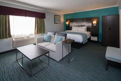 a large hotel room with a bed and a couch at Symphony Inn in San Francisco