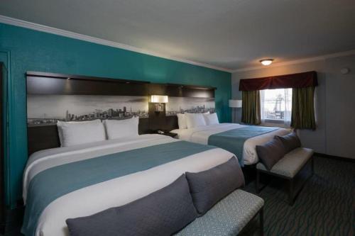 a hotel room with two beds and a window at Symphony Inn in San Francisco