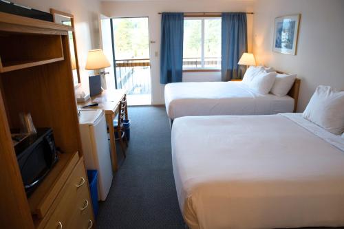 En eller flere senge i et værelse på Chalet Inn