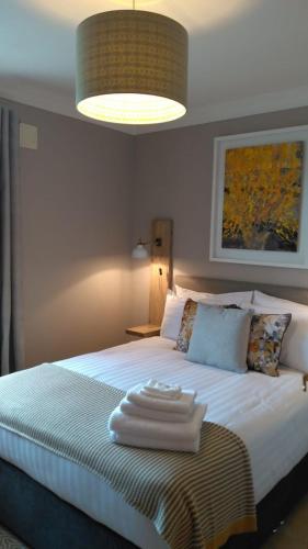 a bedroom with a bed with a towel on it at Ceol na dTonnta in Doolin