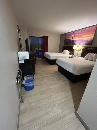 a hotel room with two beds and a painting on the wall at Park Inn in Colchester
