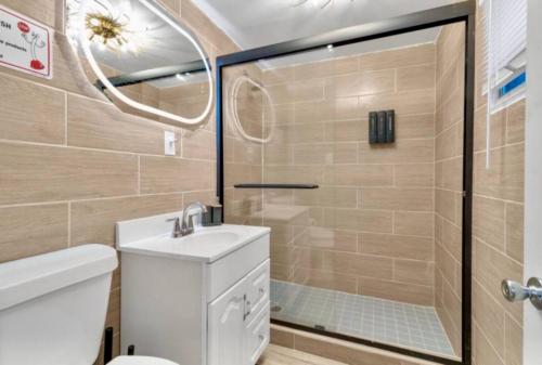 a bathroom with a shower and a toilet and a sink at Cozy Corner Buffalo Getaway in Buffalo