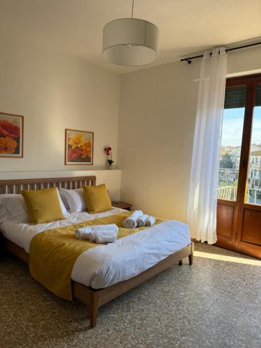a bedroom with two beds and a large window at Villa Elettra in Pisa