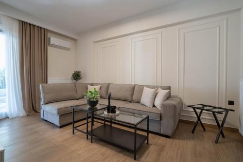 a living room with a couch and a table at The Fourth - Where Four Becomes Home in Larisa
