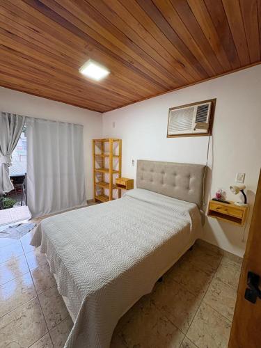 a bedroom with a large bed with a wooden ceiling at La Faustina in Chajarí