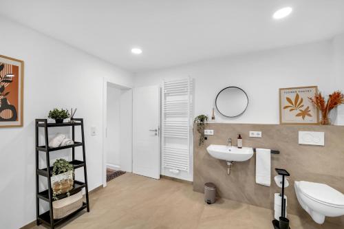 a bathroom with a sink and a toilet at INhome - Zentral - Küche - Modern in Schwäbisch Hall