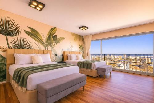 a hotel room with two beds and a balcony at Trendy Apartment in Puerto Madero in Buenos Aires