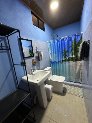 a bathroom with a sink and a toilet and a shower at Cabinas Hukats Secret Jungle in Puerto Viejo