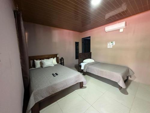 a room with two beds in a room at Cabinas Hukats Secret Jungle in Puerto Viejo