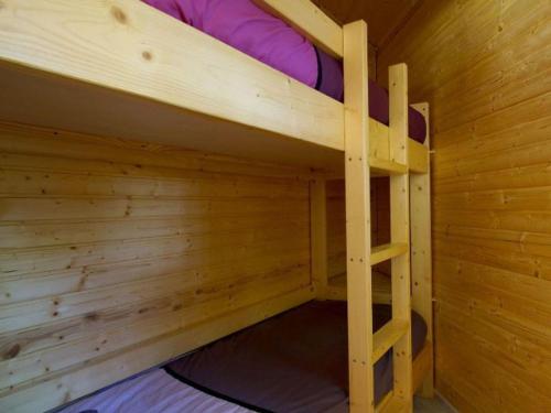 a small wooden bunk bed in a wooden cabin at Charmante Cabane 5 Pers, Chauffée - API-1-52-1704 in Champvert