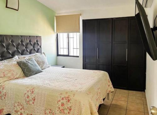 a bedroom with a bed and a large black cabinet at Casa Natalia Welcome in La Paz