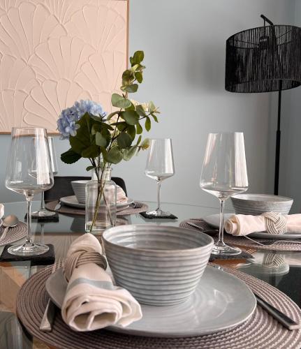 a table with plates and bowls on top of it at Howrah Apartment in Howrah