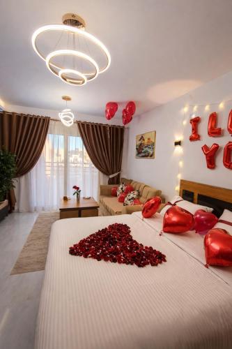 a bedroom with a large bed with red hearts on it at Luxury Studio Pool & Free Private Beach, Close to Airport in Hurghada