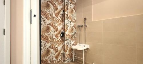 a bathroom with a shower with a toilet and a sink at Marina Boutique in Valencia