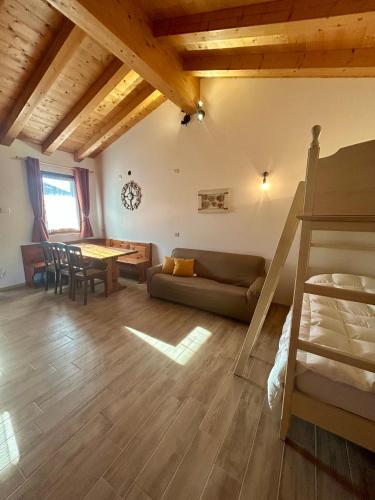 a living room with a couch and a table at Locanda B&B Da Nati in Arba