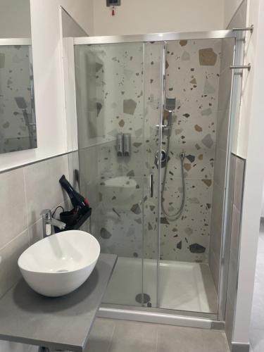 a bathroom with a shower with a sink and a toilet at Domus de janas 2 in Alghero
