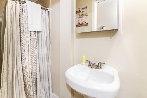 a bathroom with a sink and a shower curtain at Spacious 2BR Apt • Free Parking • Baden in Baden