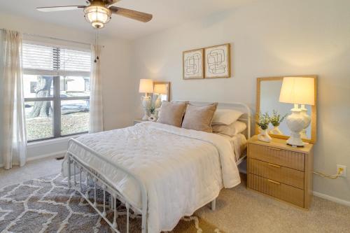 a bedroom with a large bed and a mirror at Groups Welcome, Central Location! Tulsa Gem + Yard in Tulsa