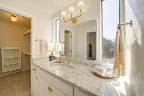 a bathroom with a sink and a mirror at Groups Welcome, Central Location! Tulsa Gem + Yard in Tulsa
