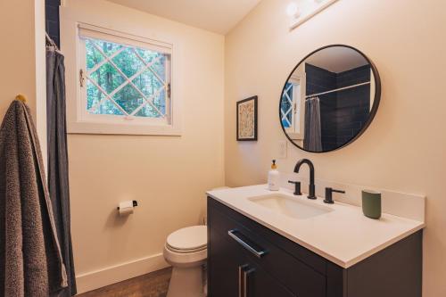 a bathroom with a sink and a mirror at Camp Hudson Pines in Corinth