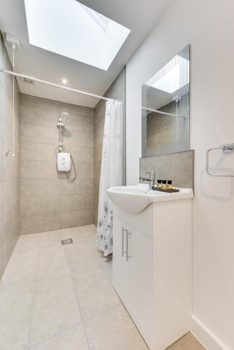a white bathroom with a sink and a shower at 3 Bed in Great Waldingfield oc-ac2 in Waldingfield