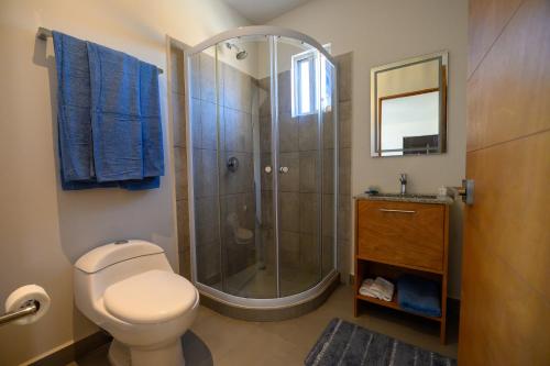a bathroom with a shower with a toilet and a sink at Departamento La Paloma in Cabo San Lucas