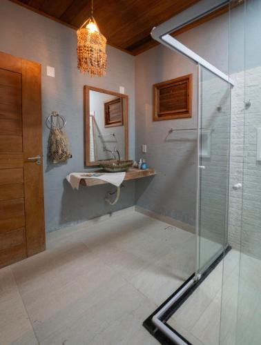 a bathroom with a sink and a shower at Atins - Vila Mani com piscina in Atins
