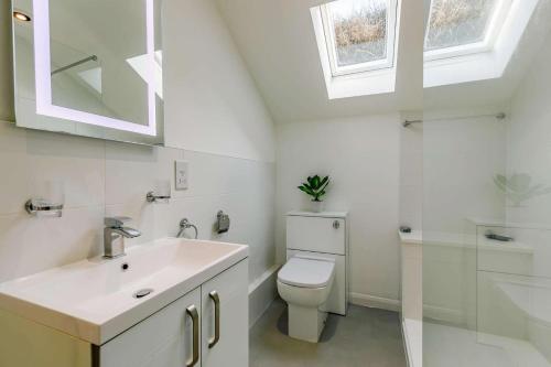 a white bathroom with a sink and a toilet at 3 Bed in Porthleven oc-1seav in Porthleven