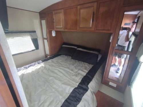 an overhead view of a bed in an rv at Cozy Camper at Howland's Hideout in Sampson