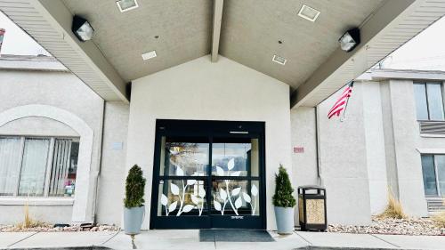 a front door of a building with an american flag at Sleep Inn South Jordan-Sandy in South Jordan