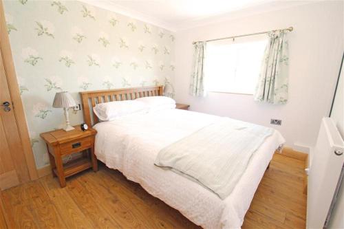 a bedroom with a bed and a window at 1 Bed in Gower oc-hh80 in Oxwich